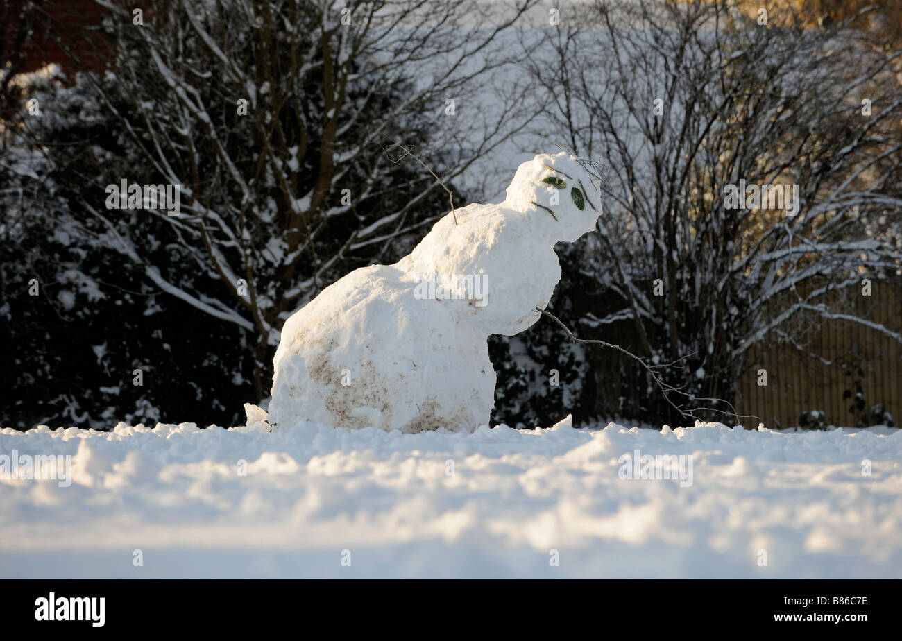 A melting snowman leaning over to one side and looking very sad. Picture by Jim Holden. Stock Photo