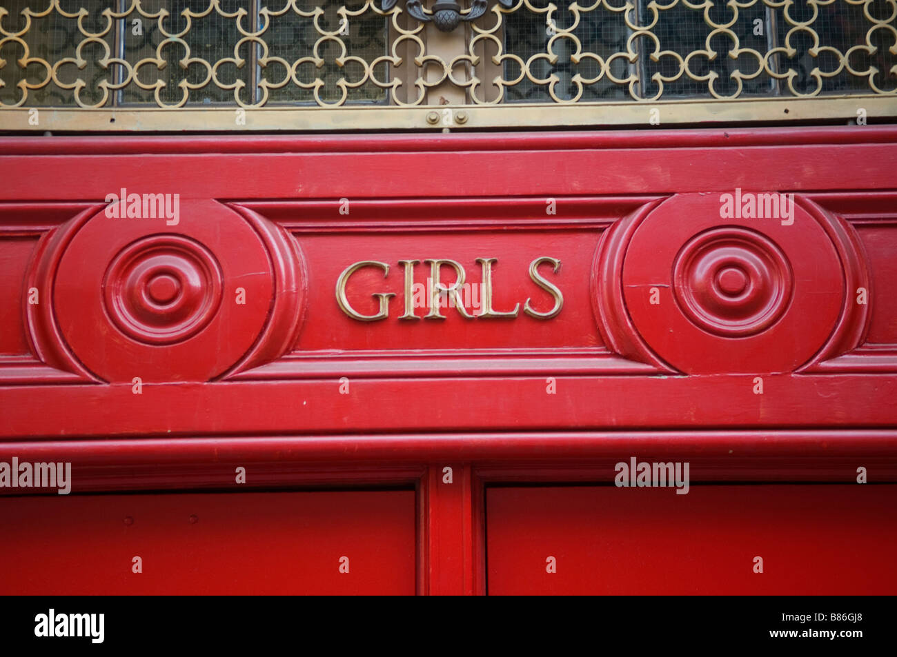 Red school door entrance for girls at a public school Stock Photo