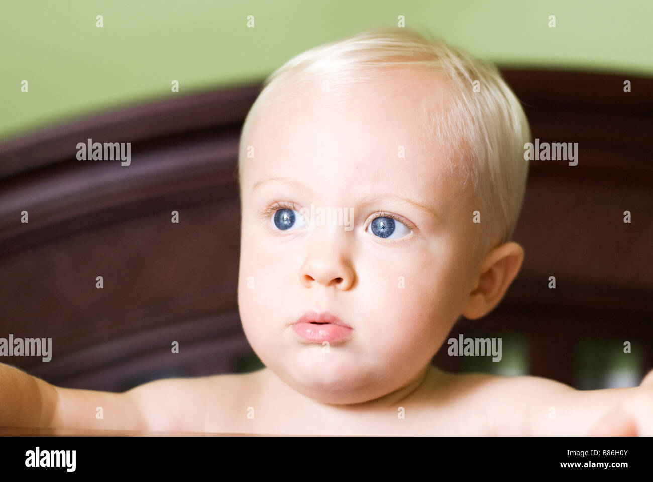Baby standing in crib Stock Photo Alamy