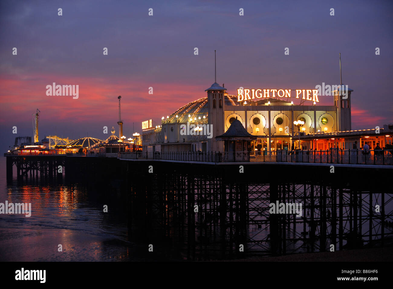 Brighton Pier at dusk with the night life just starting. Picture by Jim Holden. Stock Photo