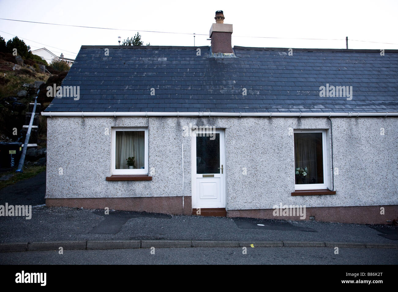 exterior small simple house in Tarbert, Harris, Scotland. UK Stock