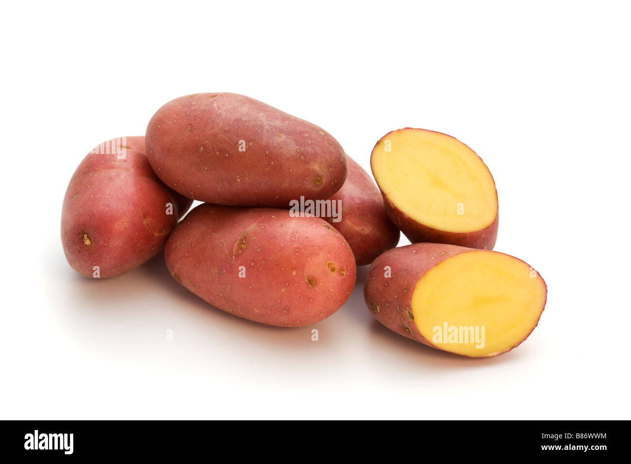 small french red potatos, one halved, isolated on white background Stock Photo