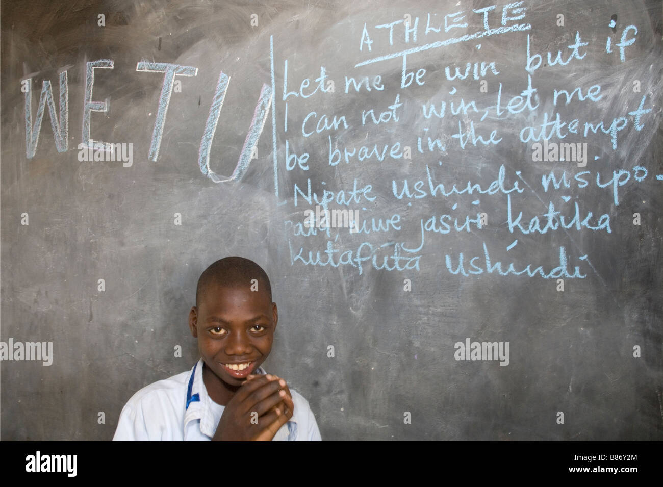 Girl with an intellectual disability writing on a blackboard,  Mabogini, Kilimanjaro Region,  Tanzania Stock Photo