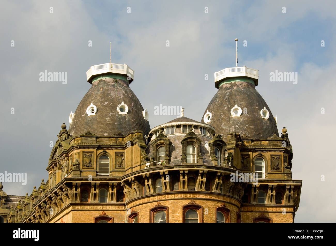 The Grand Hotel in Scarborough: Closeup of the bowed façade with its decorative cornice and two of its four slate tiled cupolas. Stock Photo
