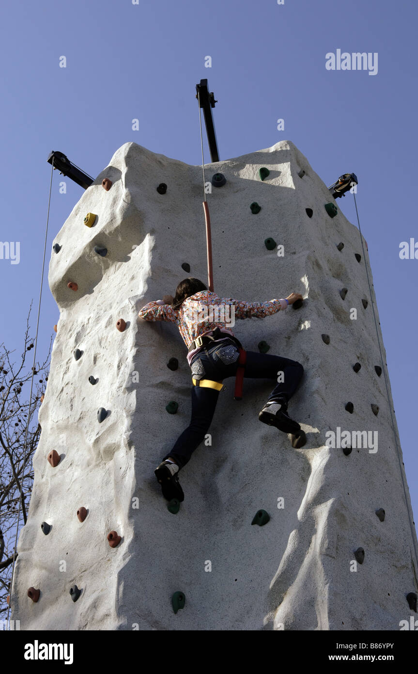 A young girl climbs up the climbing wall at the Winter Jam festival at