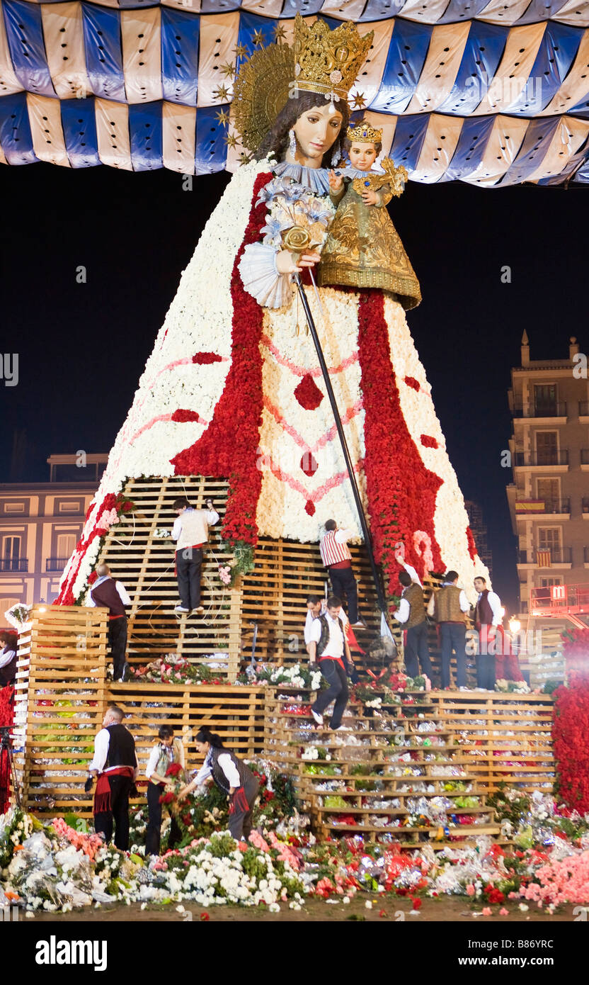 LARGE WOODEN REPLICA STATUE OF OUR LADY OF THE ABANDONED OR NUESTRA SEÑORA DE LOS DESPAMPARADOS WHICH IS ADORNED WITH FLOWERS Stock Photo