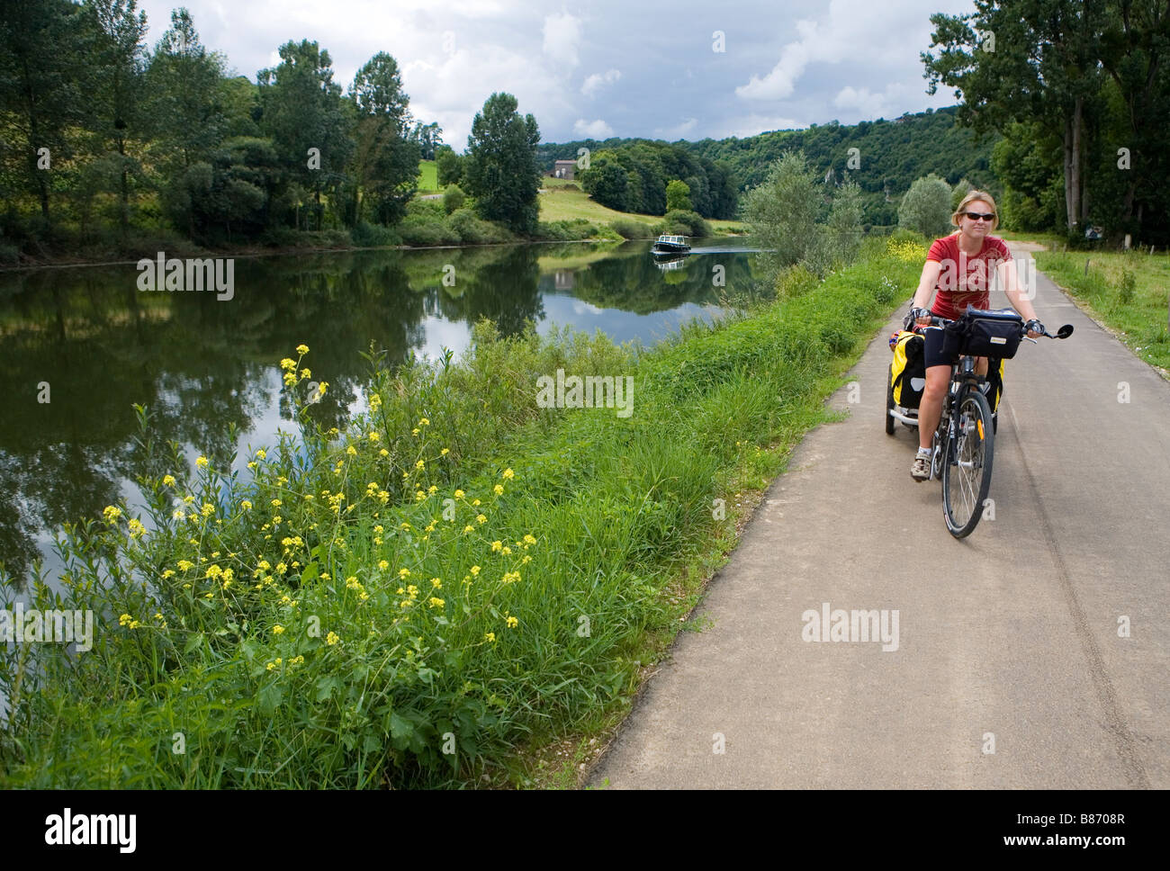 Cycling on the towpath along the Doubs River Stock Photo