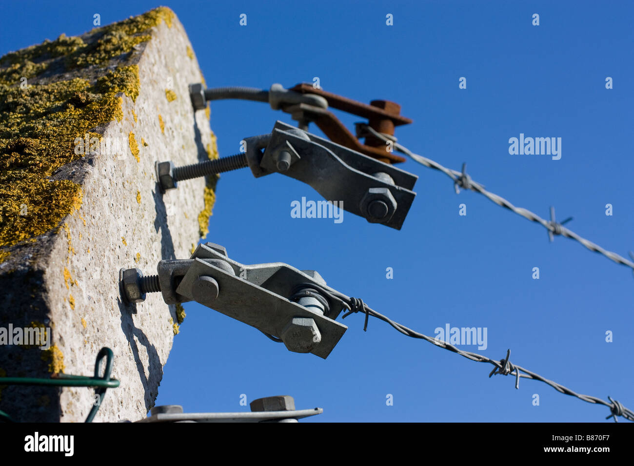 3 Galvanised barbed wire tensioners attached to pre cast concrete post