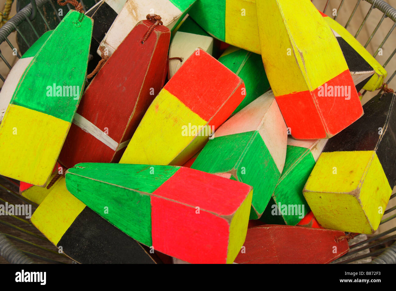 a basket of brightly colored wood souvenir buoys souvenirs in a basket Stock Photo