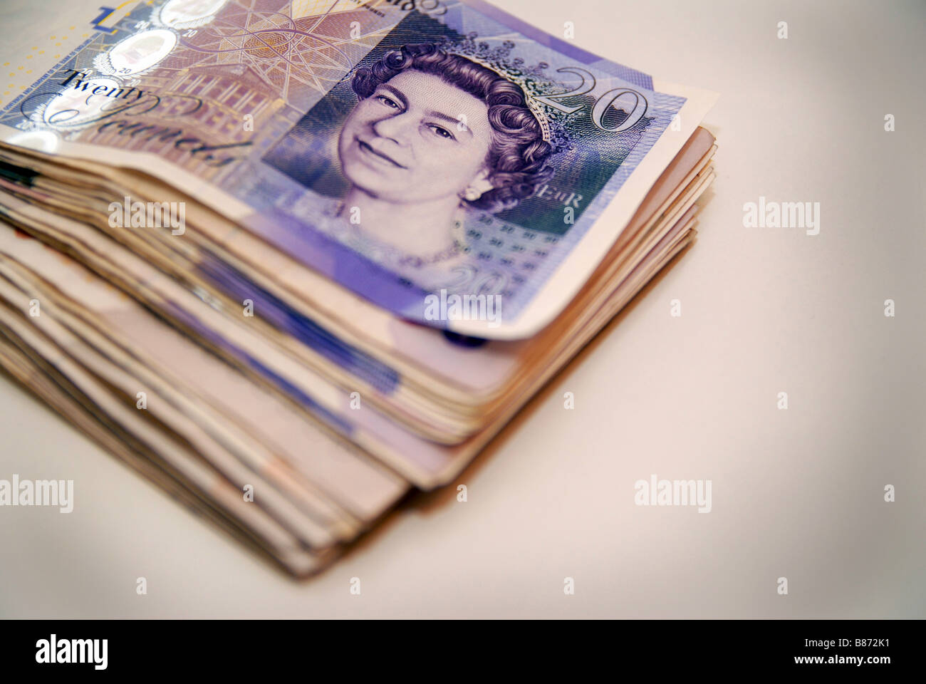 A stack / pile of used £20 Stirling bank notes, used notes ( currency