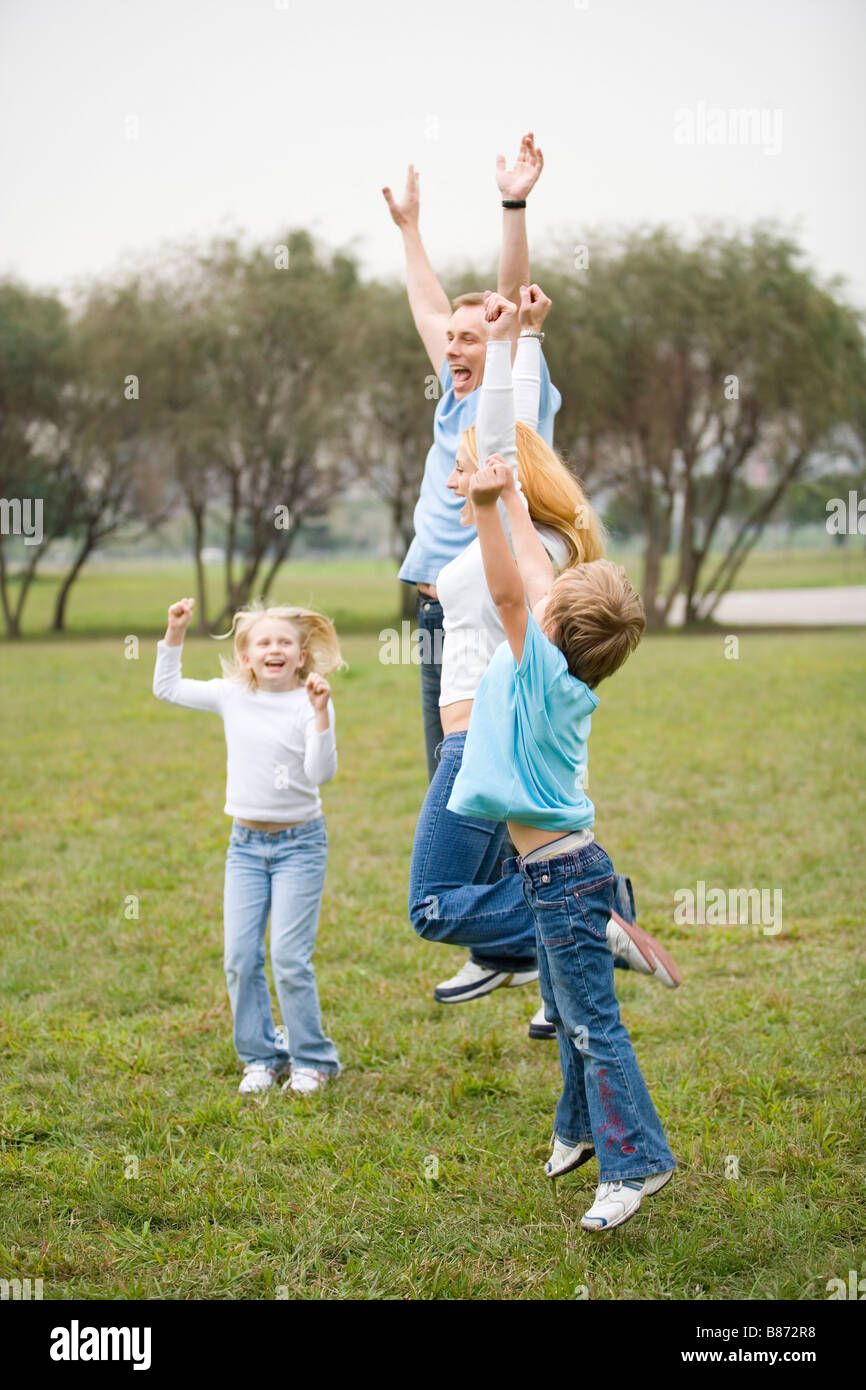 Children jumping in air in park hi-res stock photography and images - Alamy