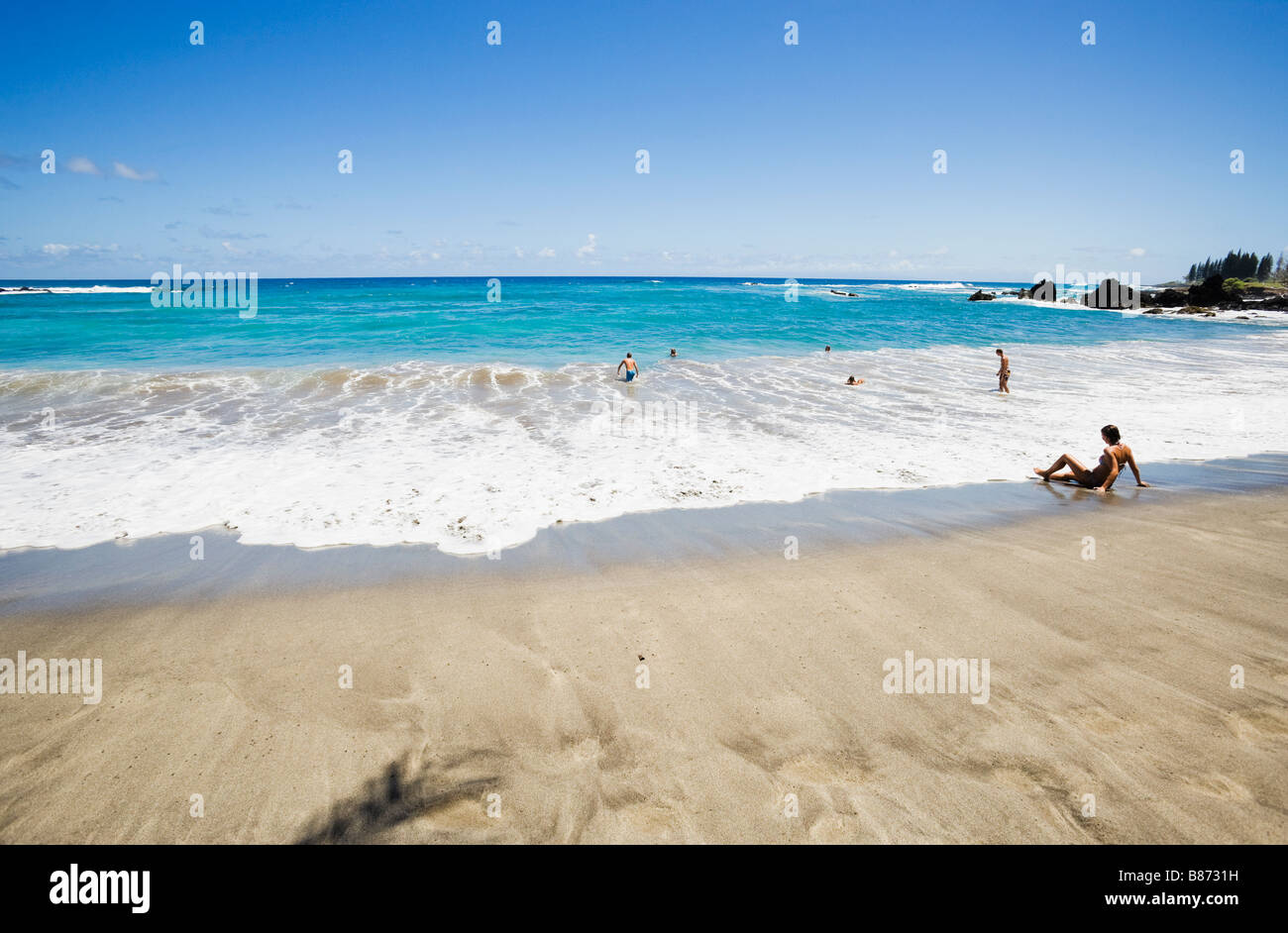 Tourists enjoying the surf at Hamoa Beach Maui Hawaii Stock Photo