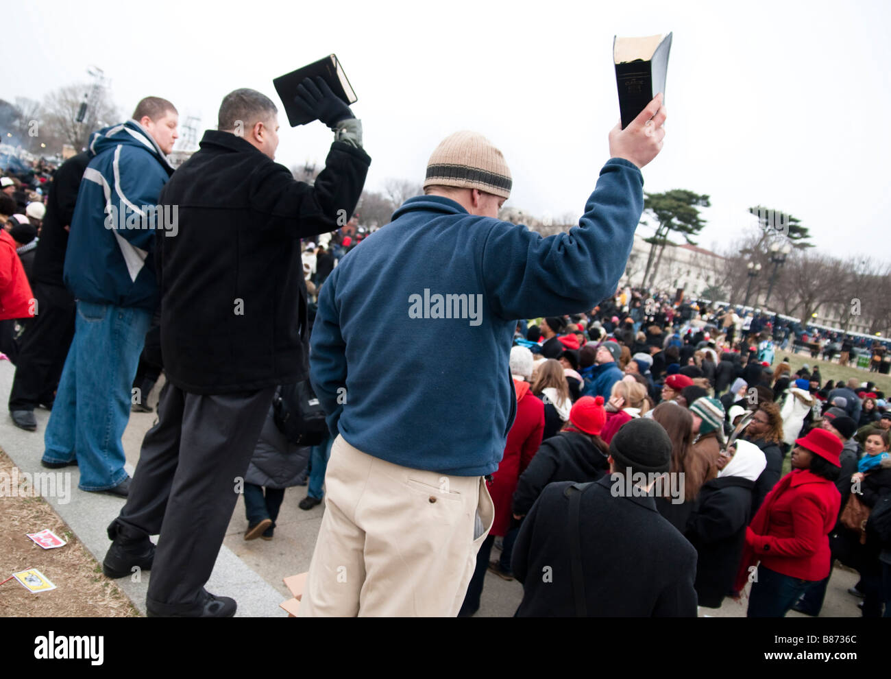 Fundamentalist evangelical Christians wave Bibles at crowds celebrating the inauguration of Barack Obama Stock Photo