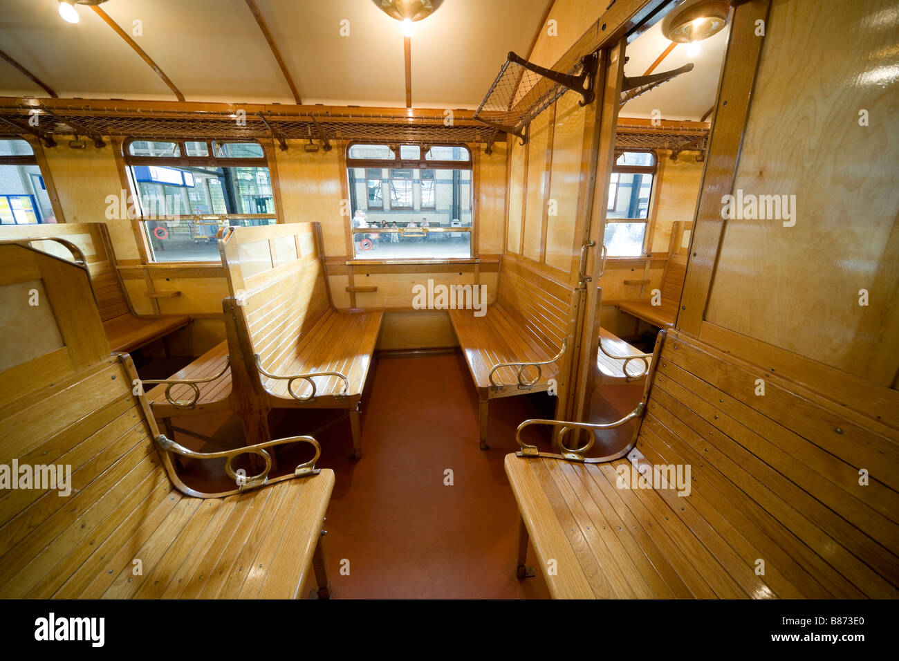 Interior of a Dutch International early 20th century railway carriage, made 1923 in Haarlem by Beynes. 3rd class wooden section. Stock Photo