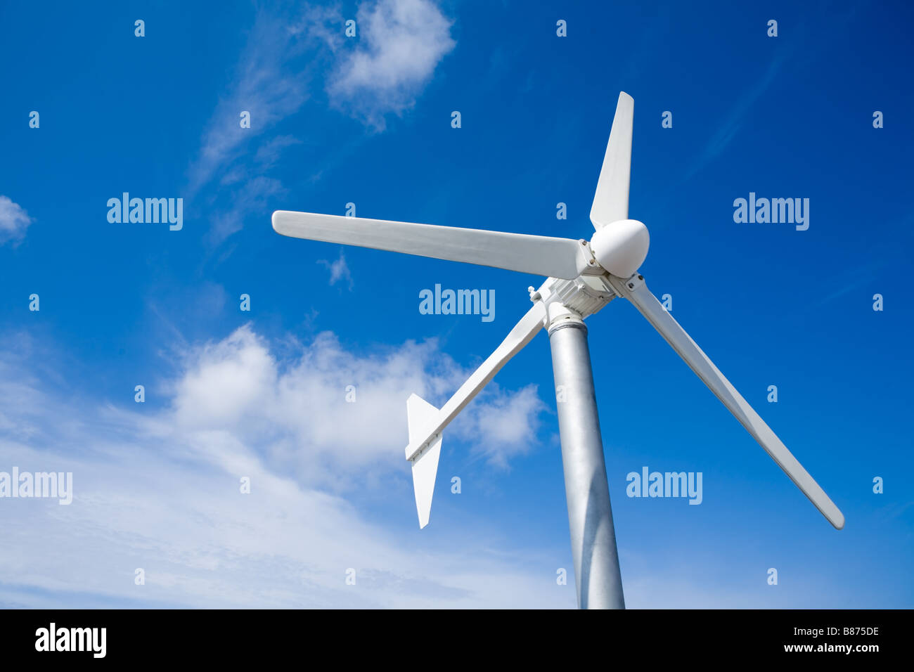 A wind turbine against a cloud blue sky Stock Photo - Alamy