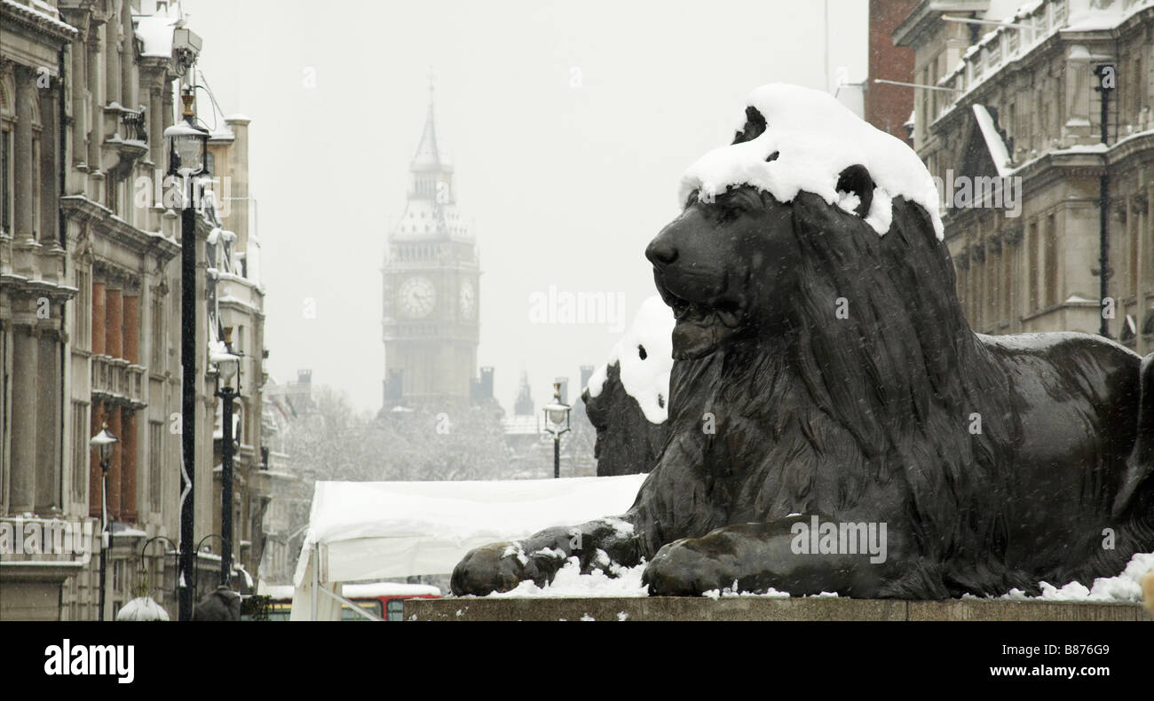 Snow on whitehall and trafalgar square lion london england uk Stock Photo