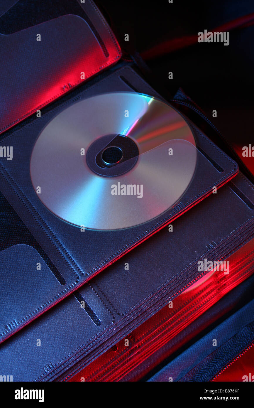 CD in a wallet lit with red and blue studio lighting Stock Photo