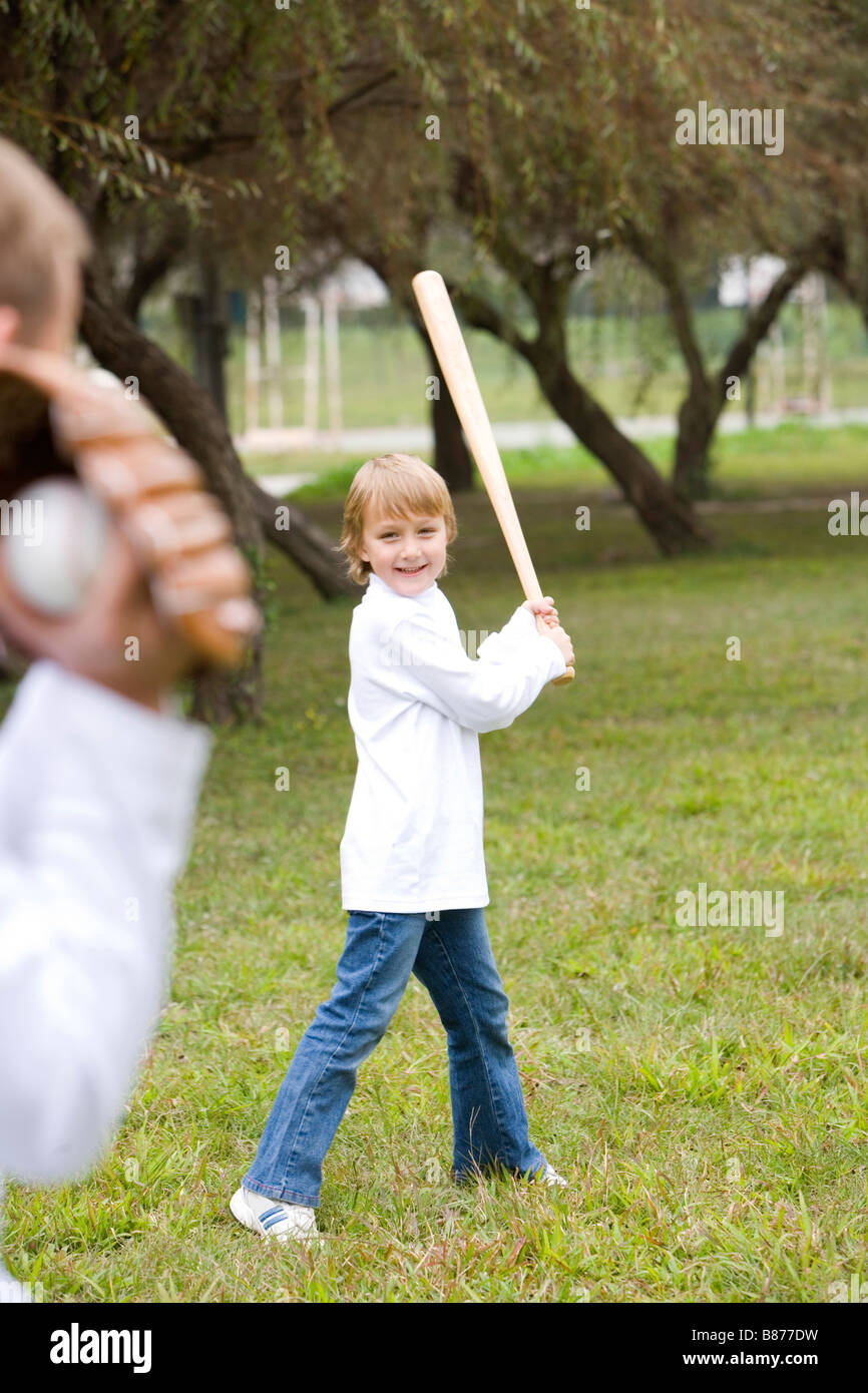 Boy playing baseball with his father Stock Photo