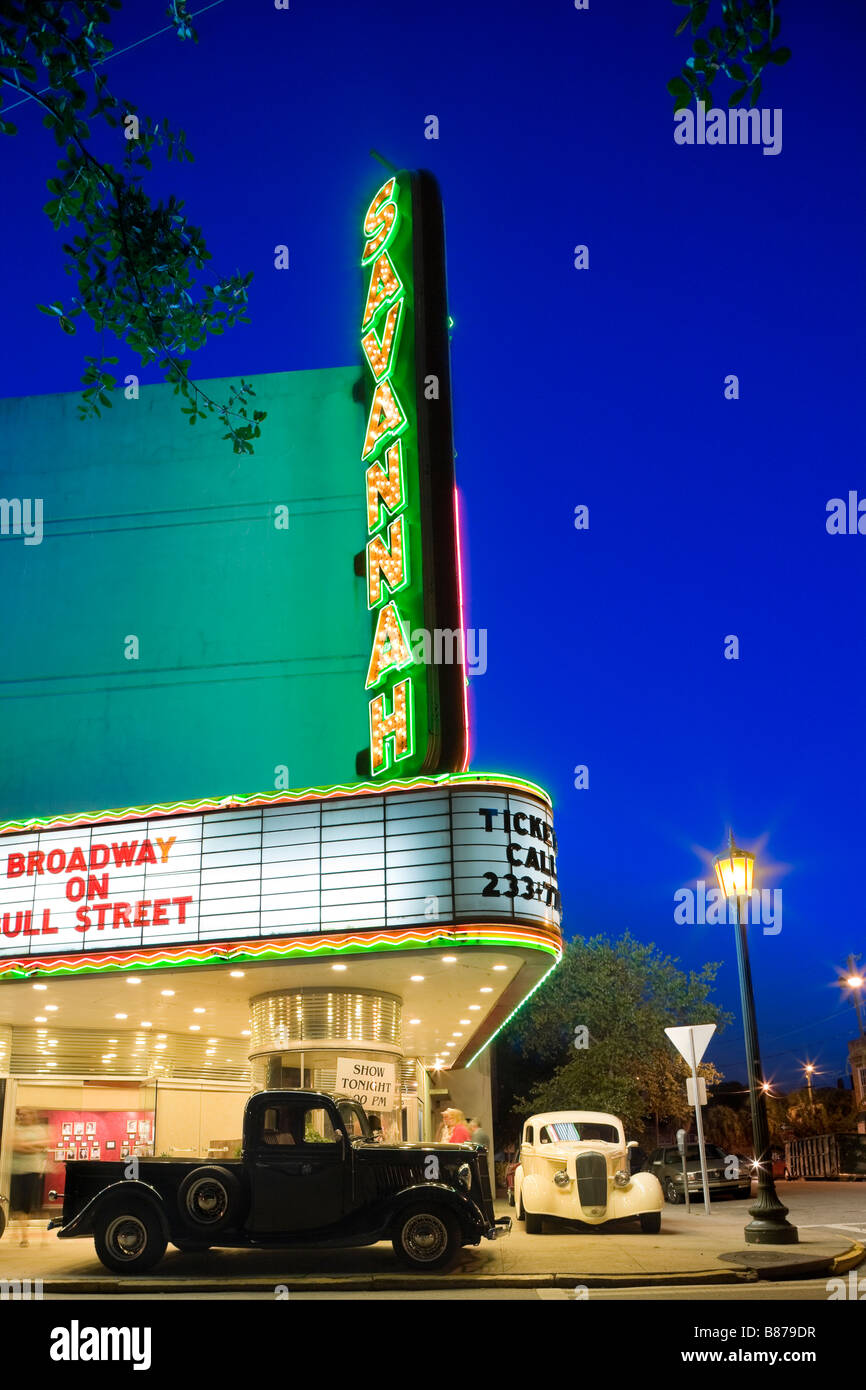 Historic Savannah Theatre in Savannah Georgia with neon sign at dusk. Two classic cars parked on the sidewalk. Stock Photo