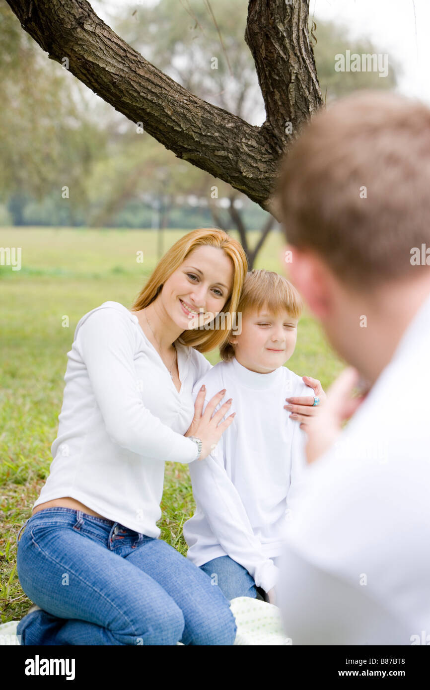 Father taking picture of his wife and son Stock Photo