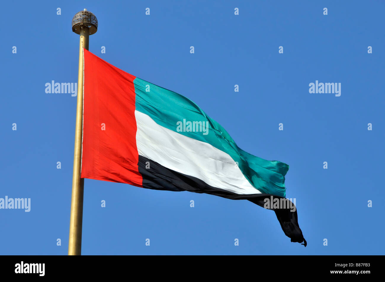 Dubai the UAE Arab Emirates flag at Jumeirah on the location of signing and formation of UAE beside Union House seen on a blue sky sunny day Stock Photo