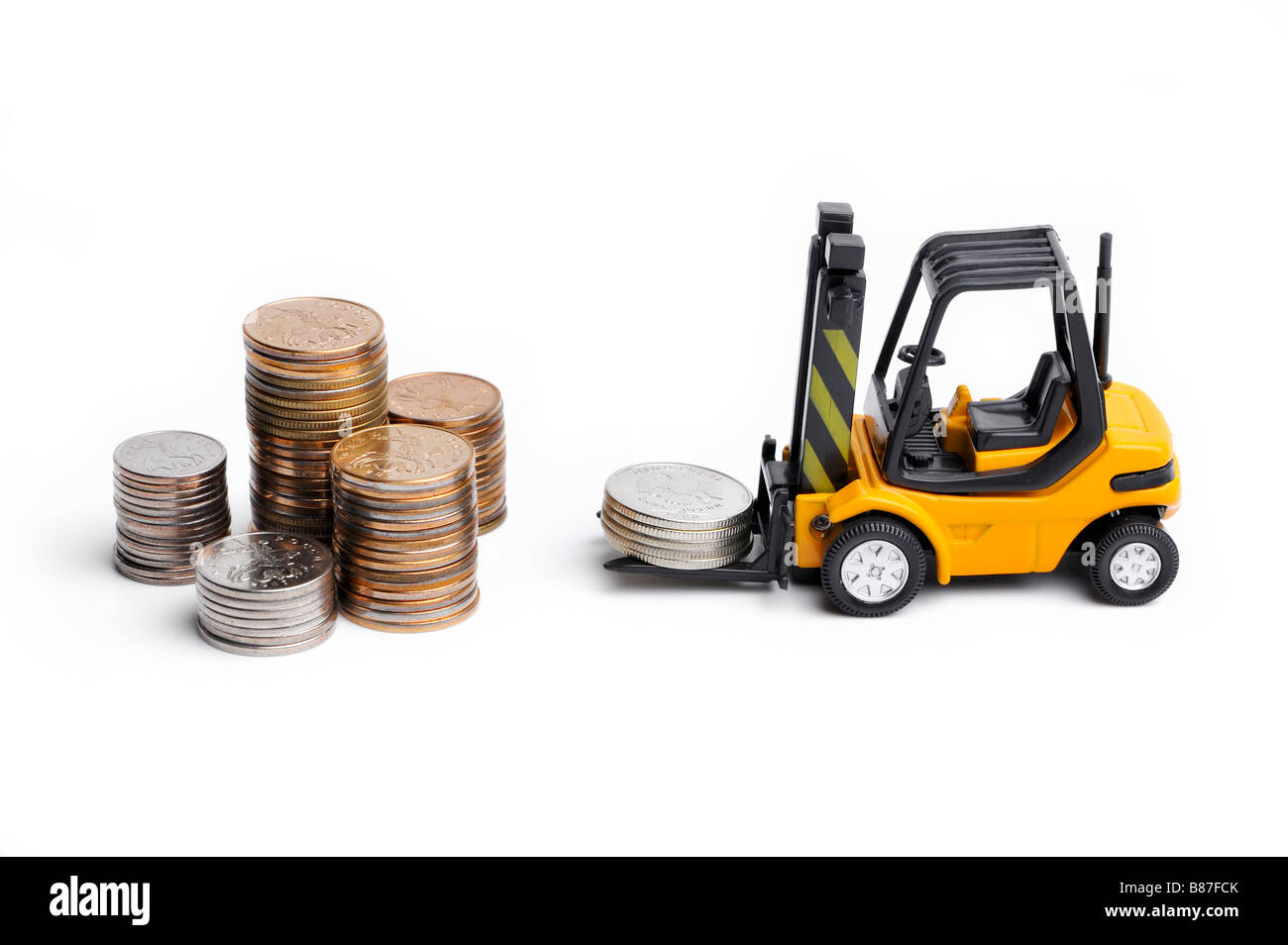 Yellow toy forklift moving stocks of coins Stock Photo
