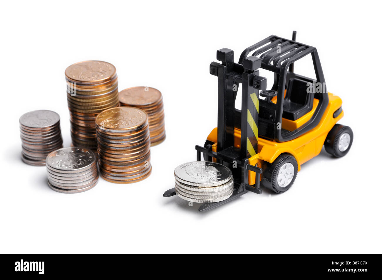 Yellow toy forklift moving stocks of coins Stock Photo