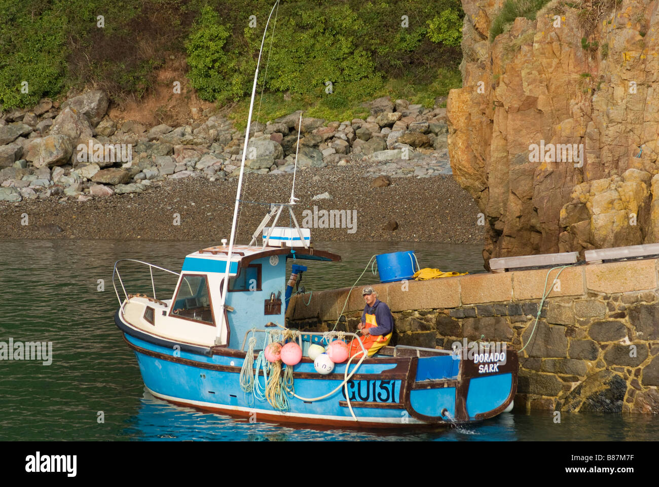 Blue Fishing Boat in Old Harbour Sark Stock Photo