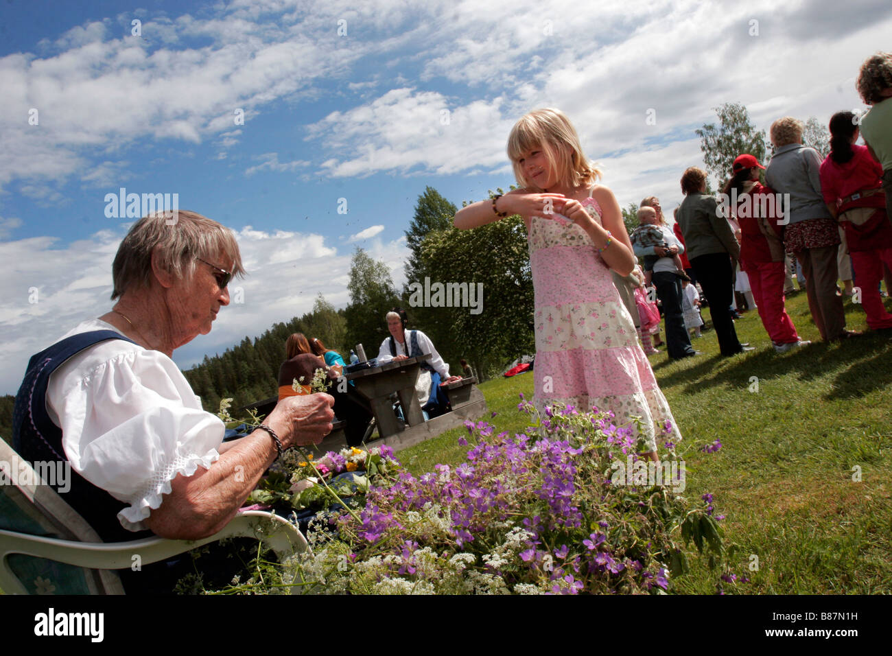 Swedish People Celebrate The Mid Summer Midsommar Festival In A Traditional Countryside