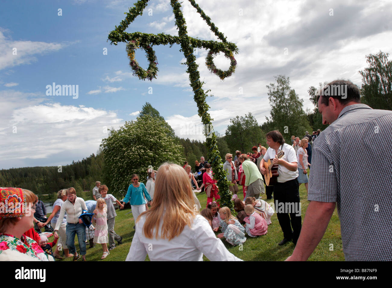 Swedish People Celebrate The Mid Summer Midsommar Festival In A Traditional Countryside