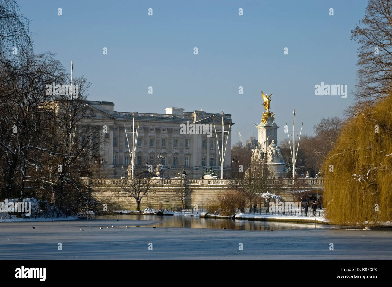View from St James Park across the lake to Buckingham Palace And the Queen Victoria Memorial in Winter snow. Stock Photo