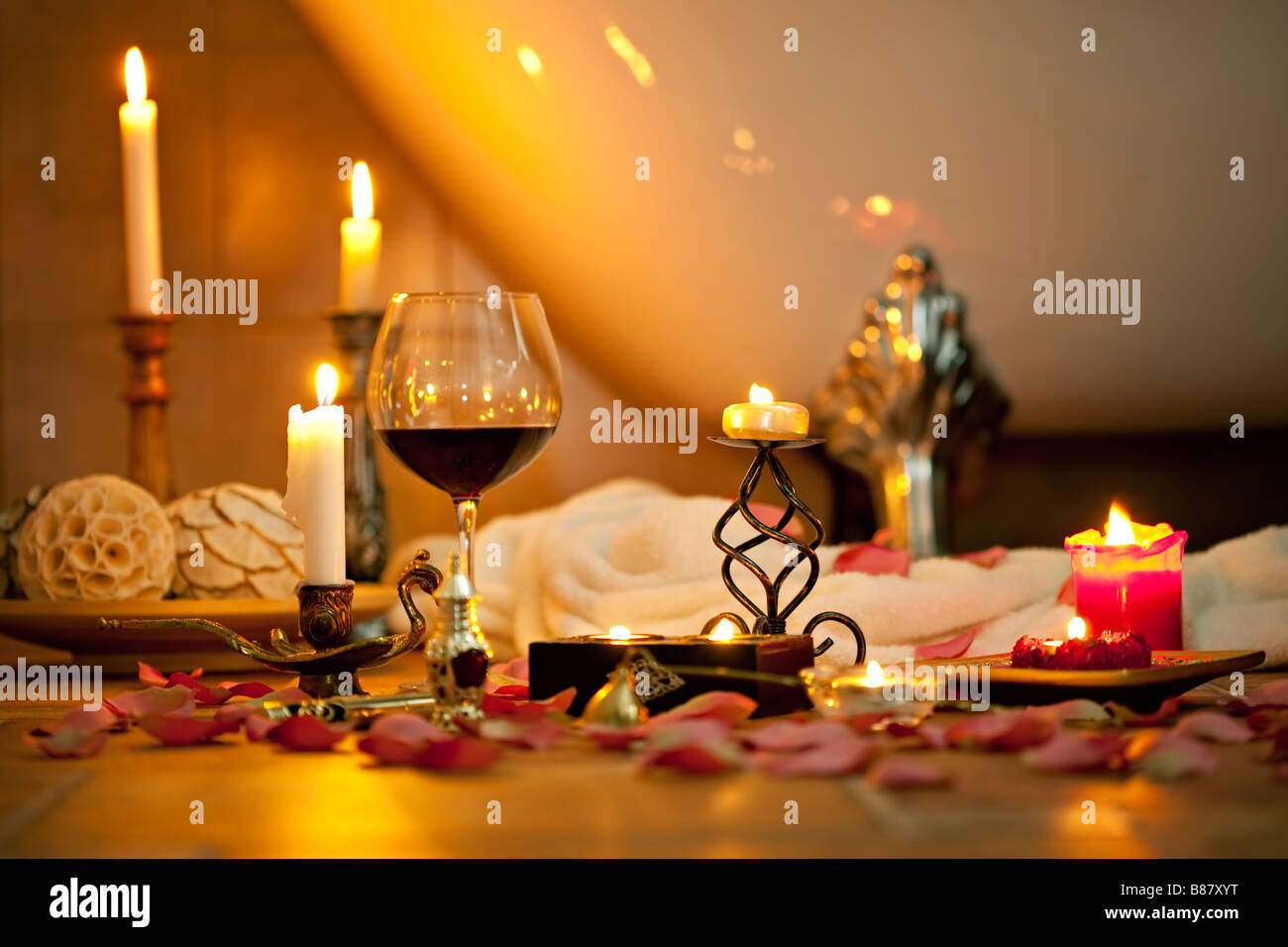 Still life with candles and red wine in the retro bathroom Stock Photo
