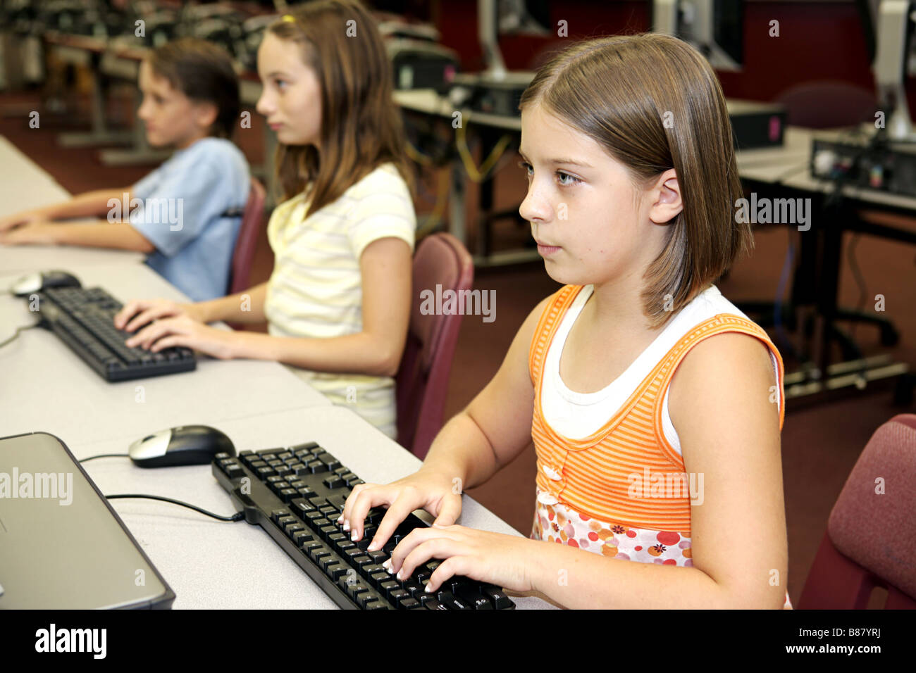 Students in the school library doing research on computers Stock Photo ...