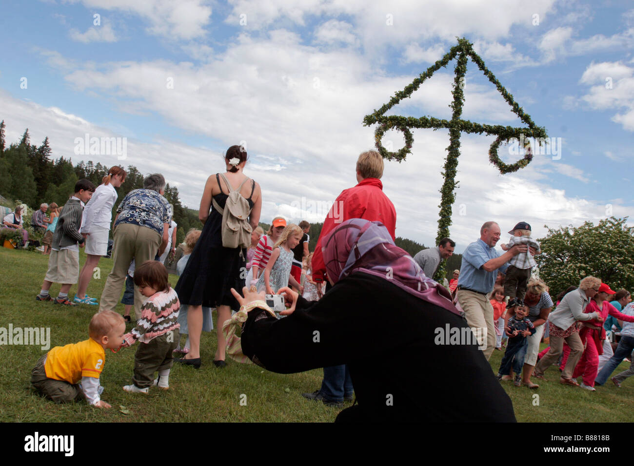 Swedish people celebrate the mid summer (midsommar) festival in a traditional countryside location Sweden. Stock Photo