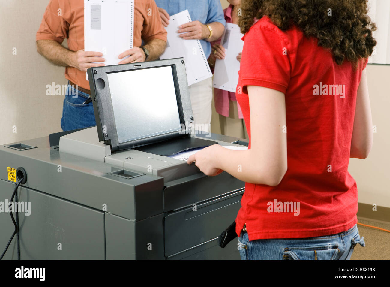 Young woman votes on florida s newest optical scanning machine Stock Photo