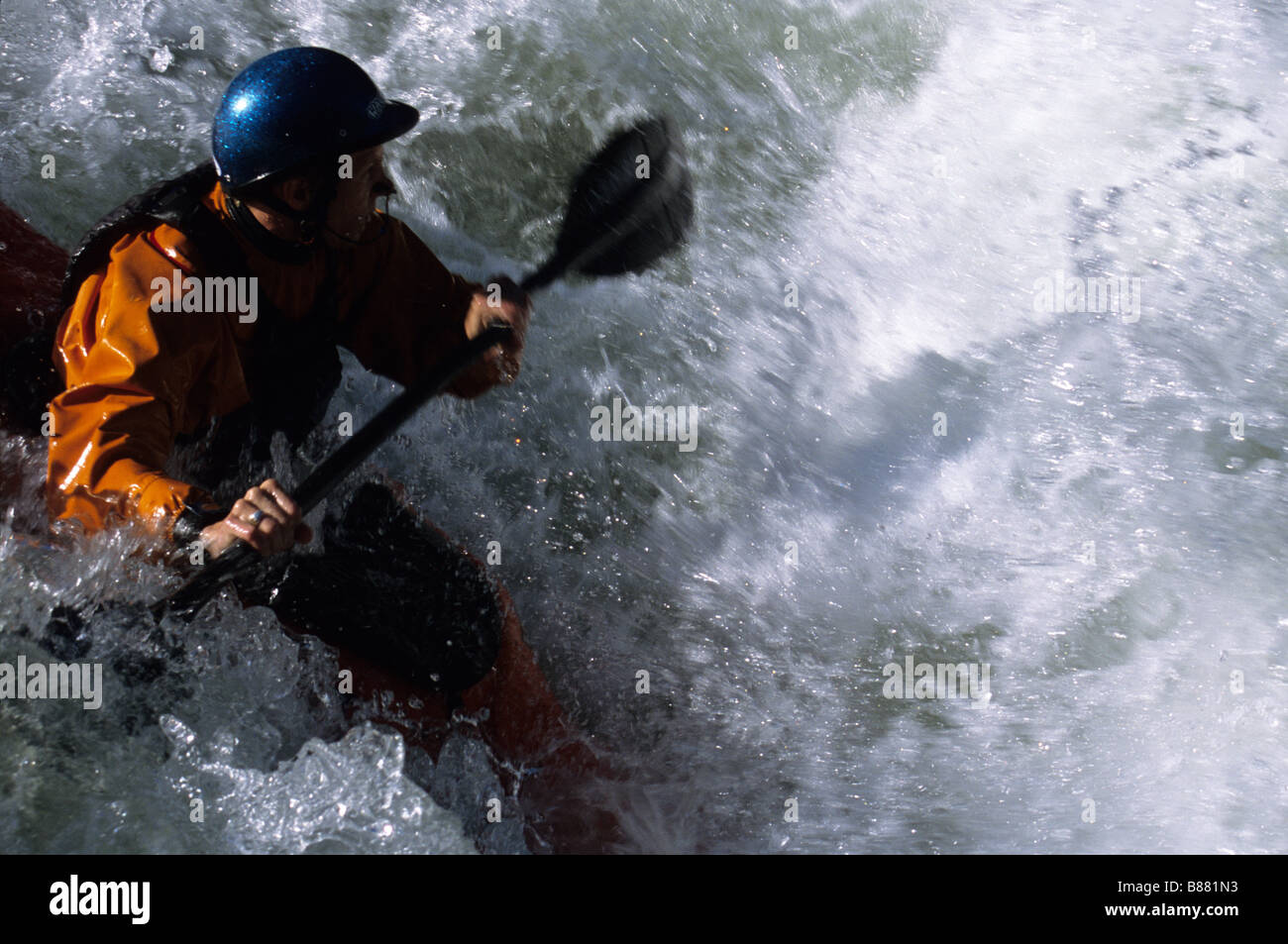 A kayaker drops a class four rapid on the Deschutes River Oregon Stock Photo