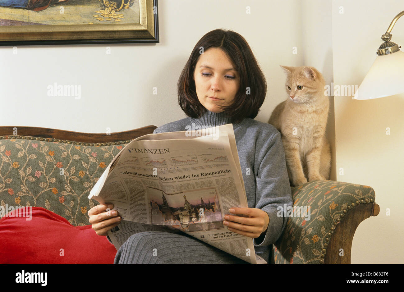 woman with domestic cat on couch Stock Photo