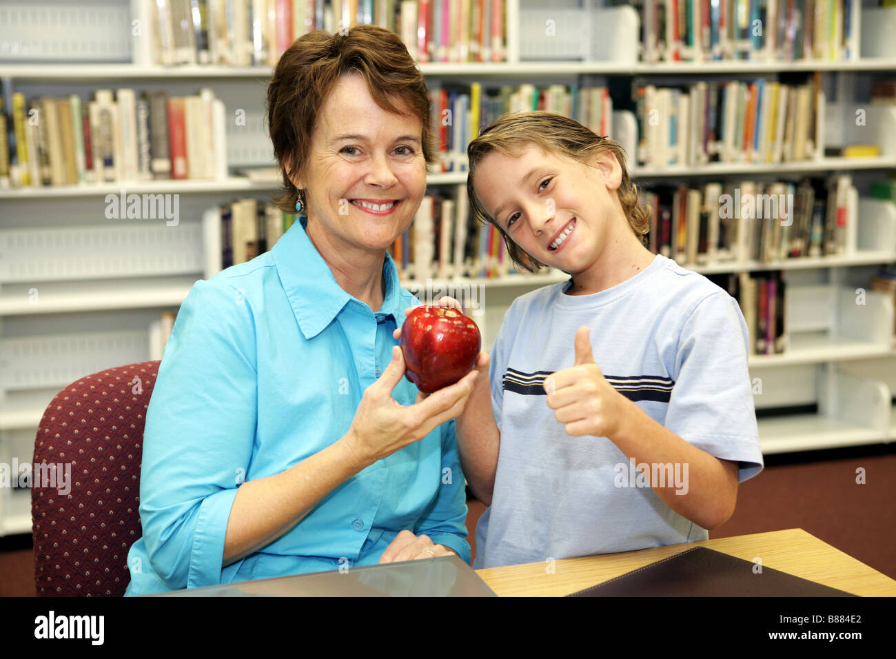 Student giving apple to teacher hires stock photography and images Alamy