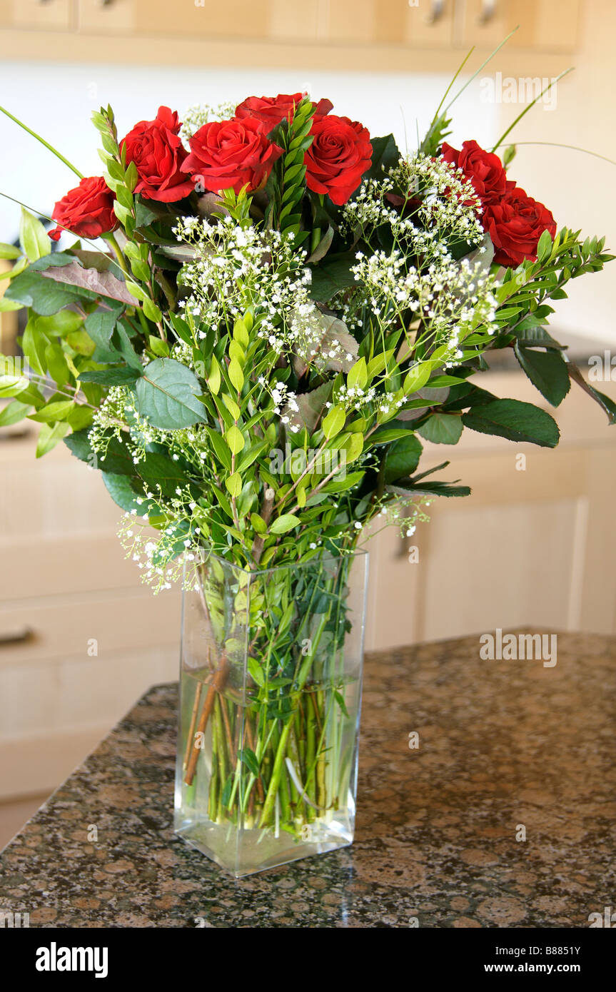 glass vase with red roses on marble work surface Stock Photo Alamy