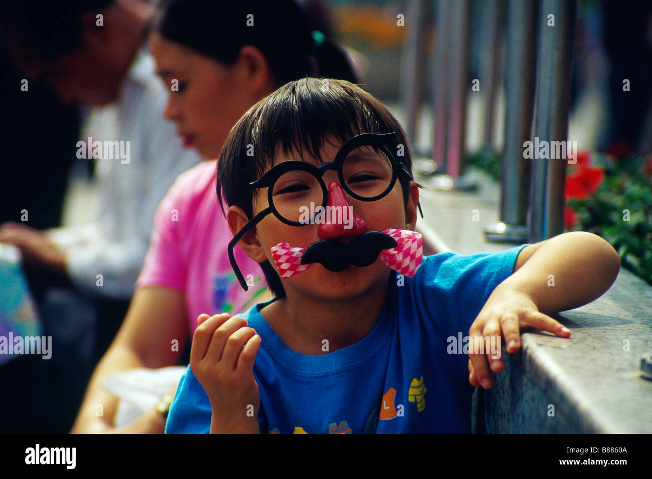 Child Young person Wearing large plastic glasses and false moustache