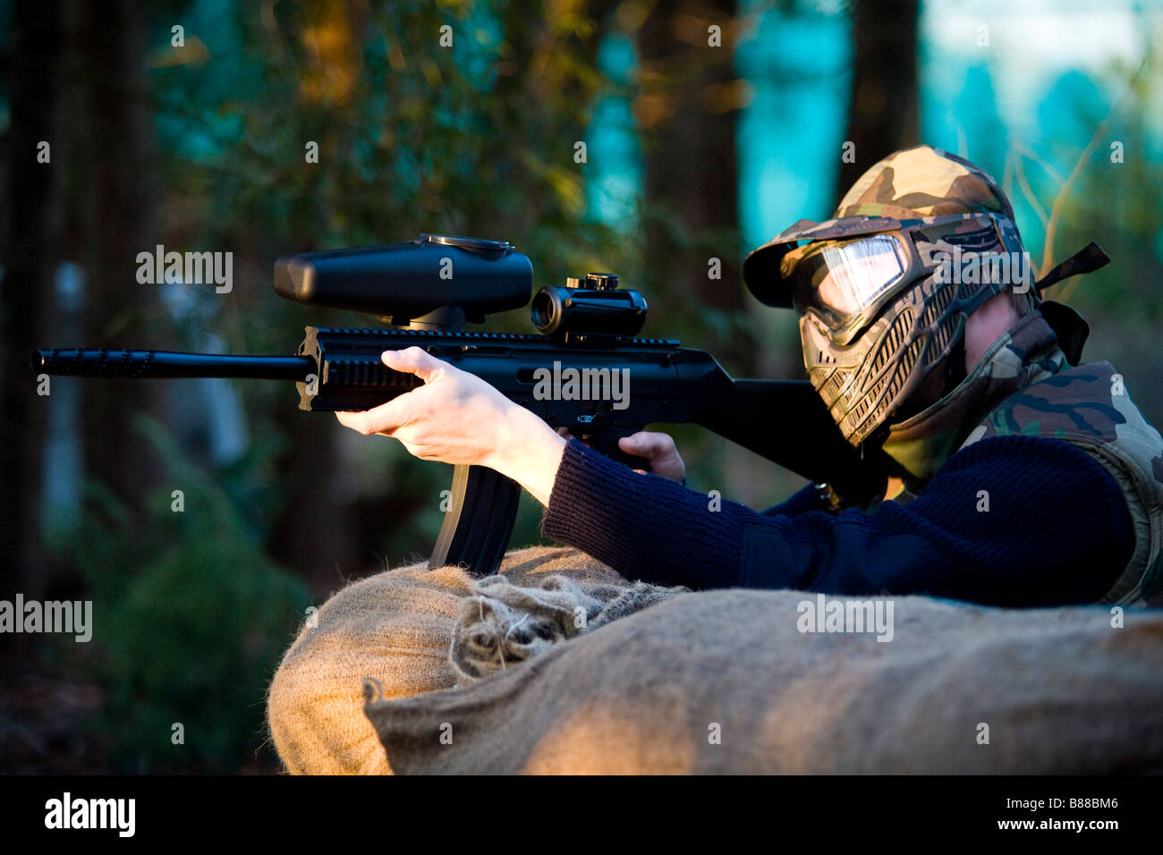 Someone aiming with a paintball marker Stock Photo Alamy