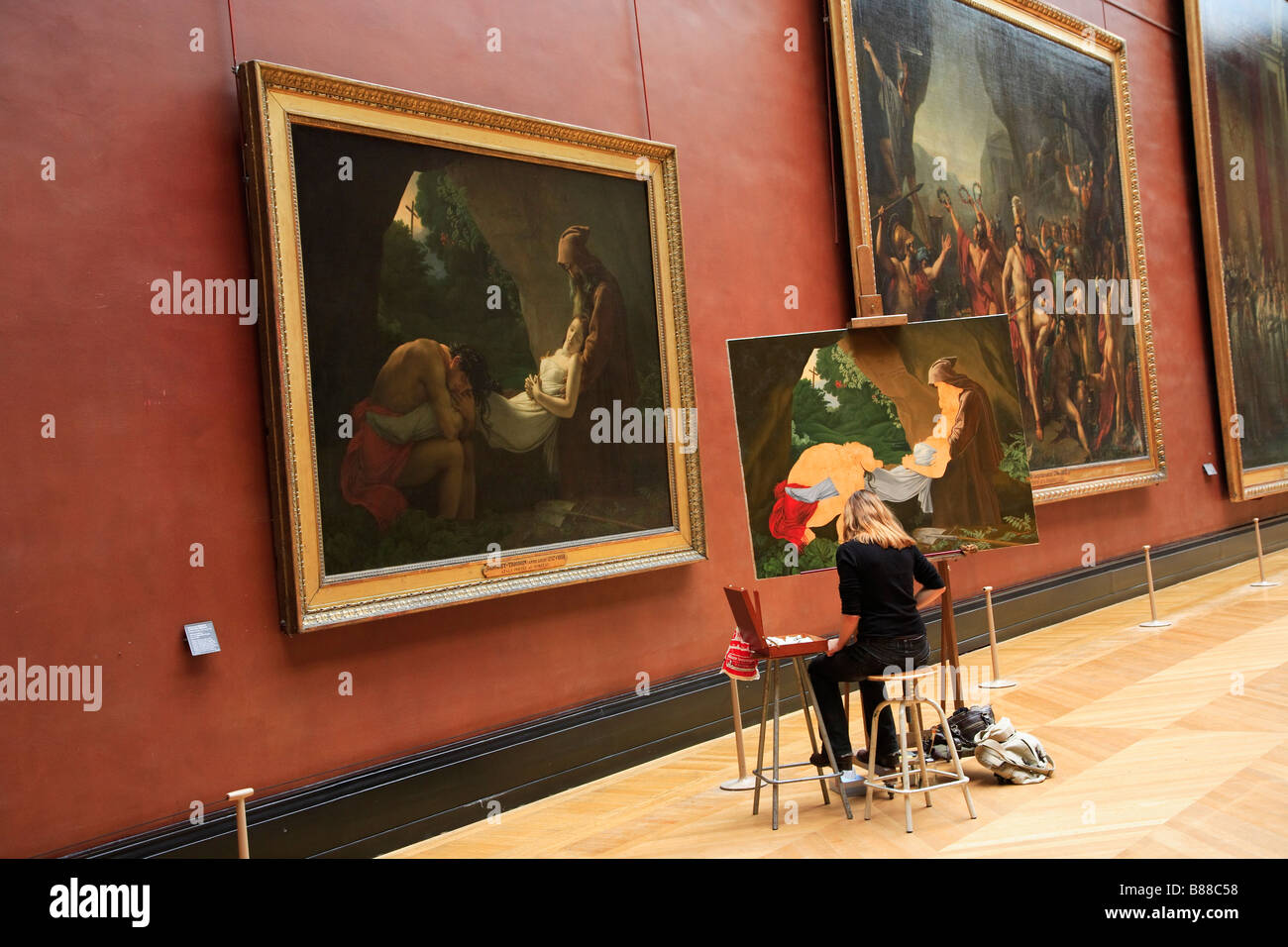 PARIS LOUVRE MUSEUM AN ARTIST REPRODUCES A PAINTING Stock Photo