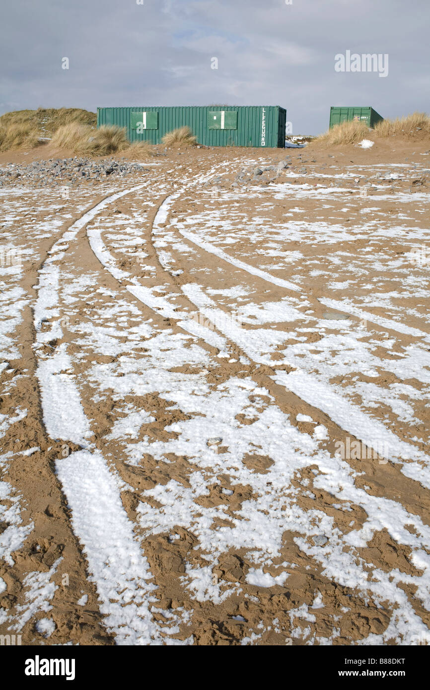 snow in ruts created by tires on Newton beach after rare snowfall Stock ...