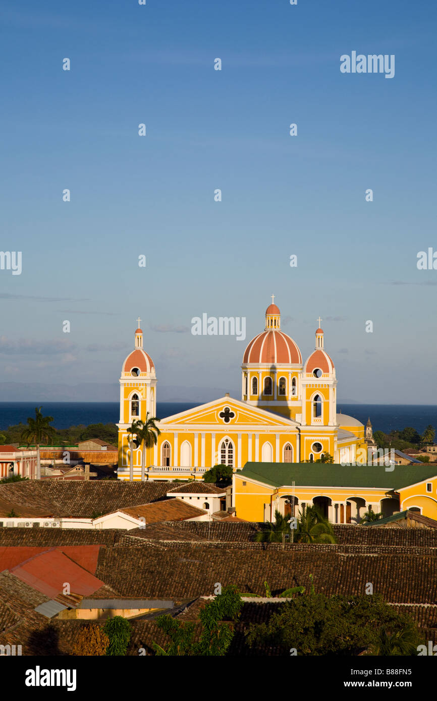 Granada Cathedral or Our Lady of Assumption Cathedral in front of Lake Cocibolca seen from the Iglesia La Merced's belltower in Granada, Nicaragua. Stock Photo