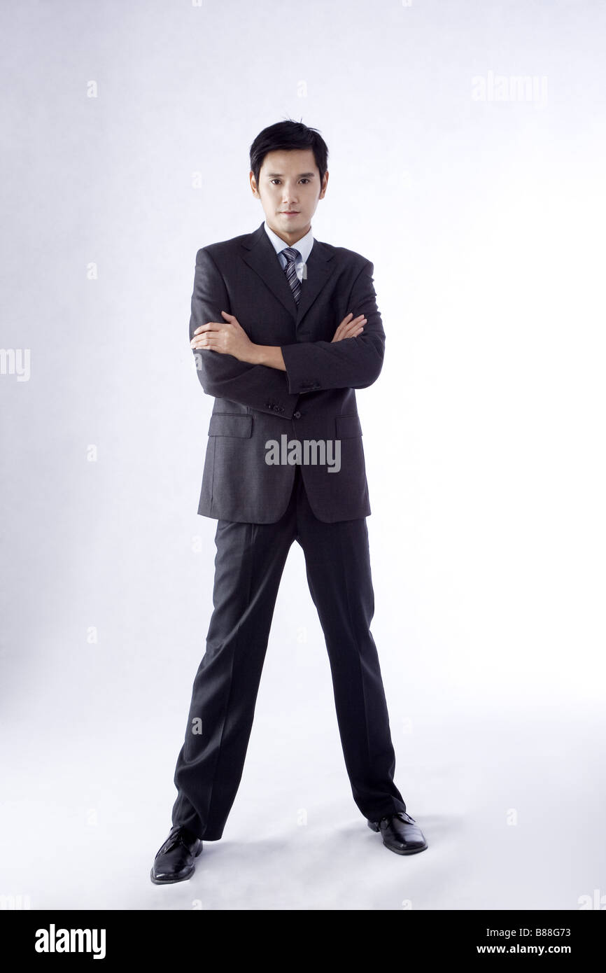Young businessman with arms crossed full length portrait Stock Photo ...