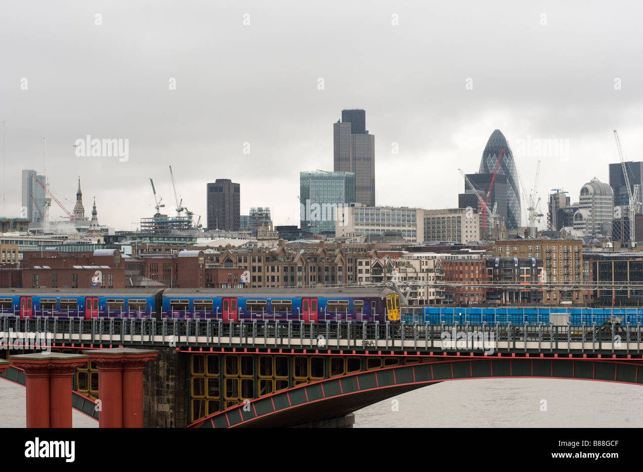 First Capital Connect train passing over the railway bridge at Blackfriars Station in the city of London England Stock Photo