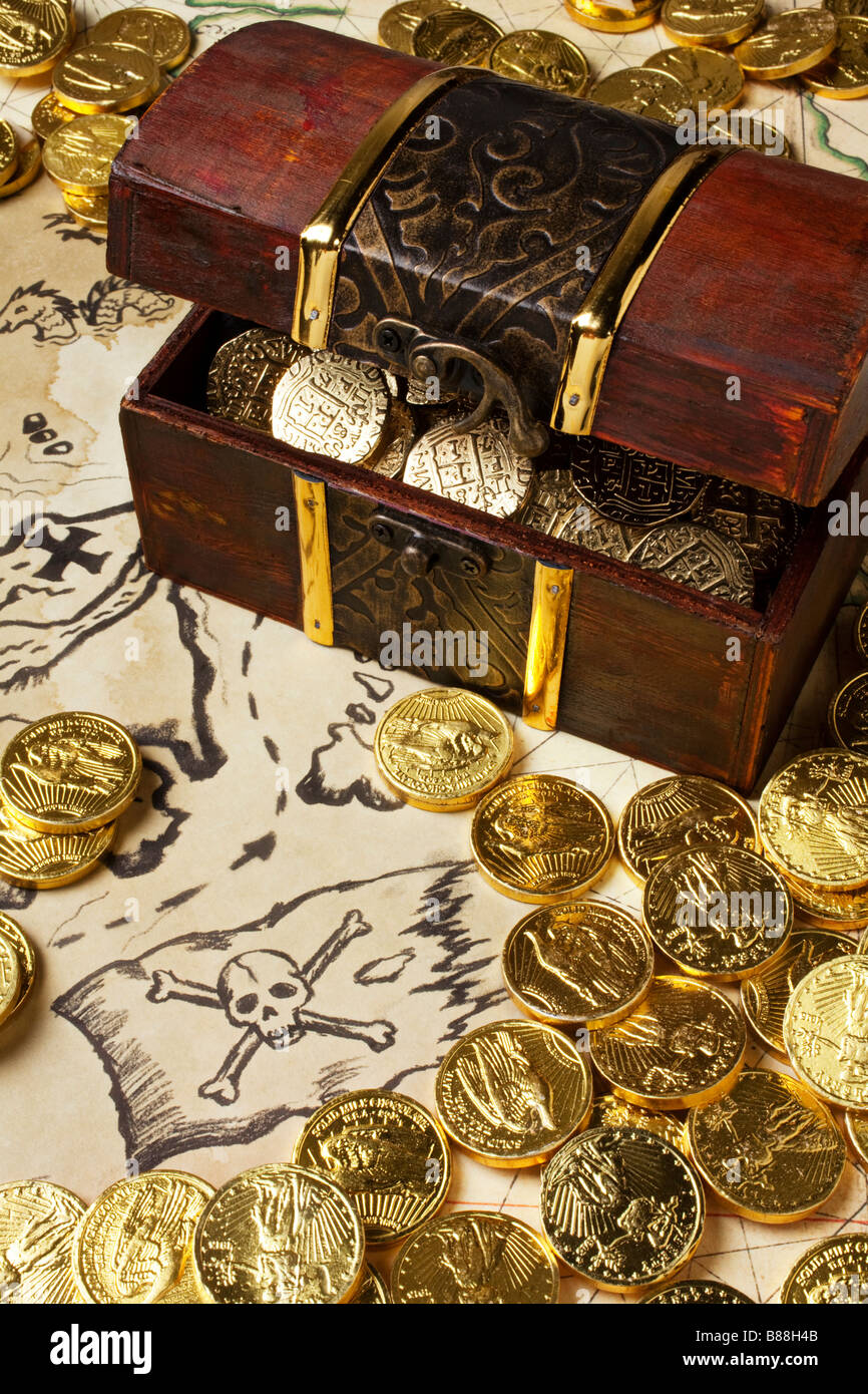 Gold coins doubloons on old map Stock Photo