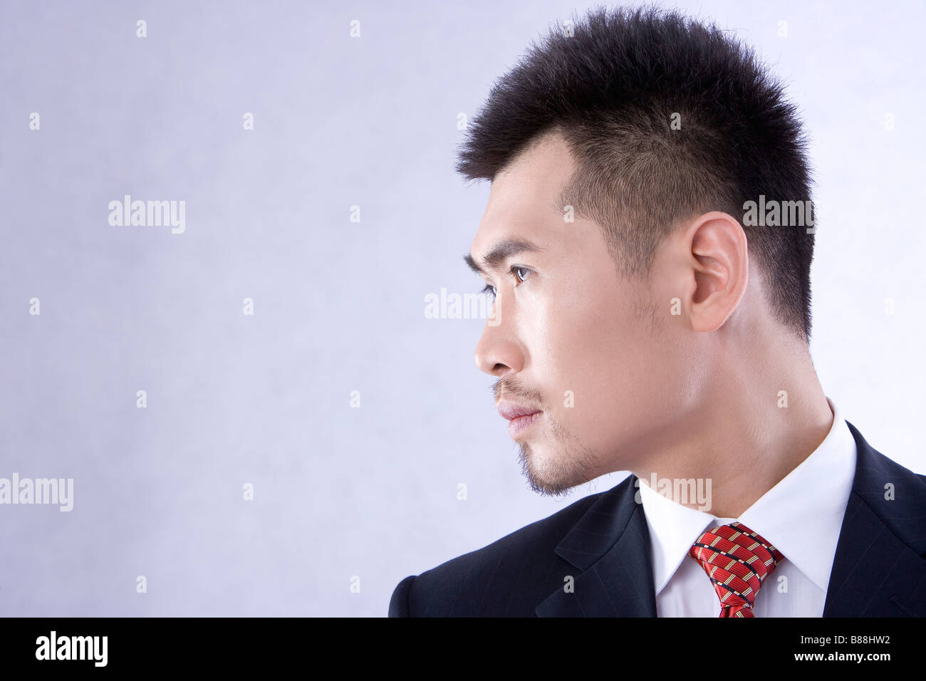 Close up of young businessman turning head aside close up Stock Photo