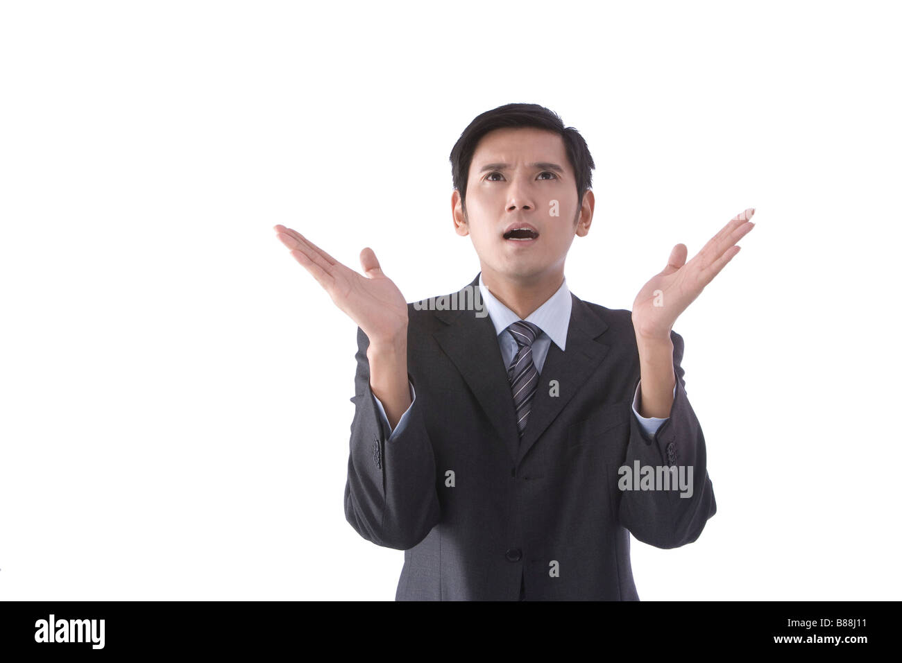 Young businessman with arms raised portrait Stock Photo - Alamy