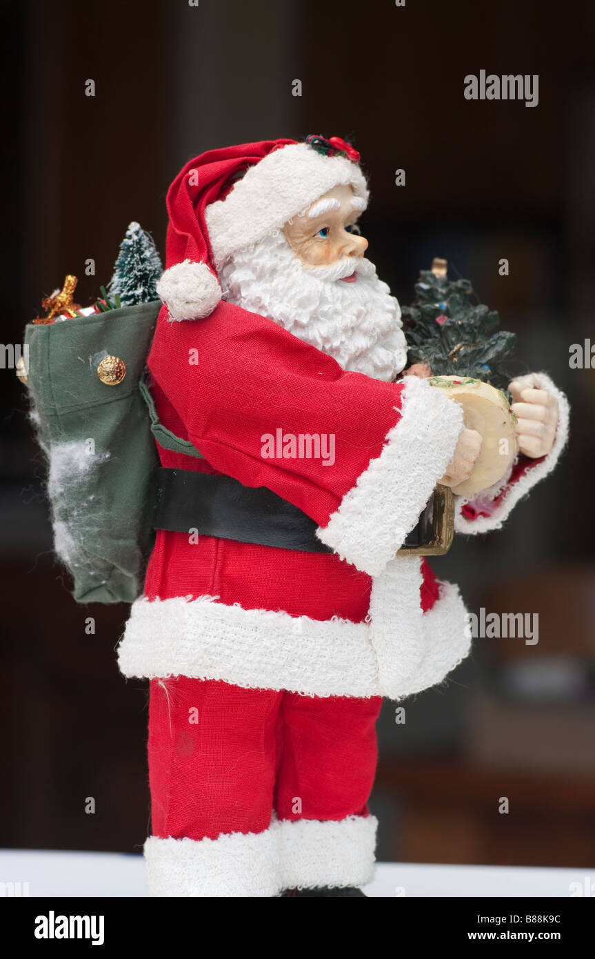 Toy Santa Claus with sack on his back and toys Stock Photo